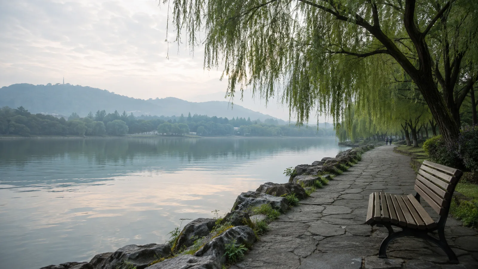 A quiet morning beside Hangzhou West Lake with willows, calm water, and distant hills