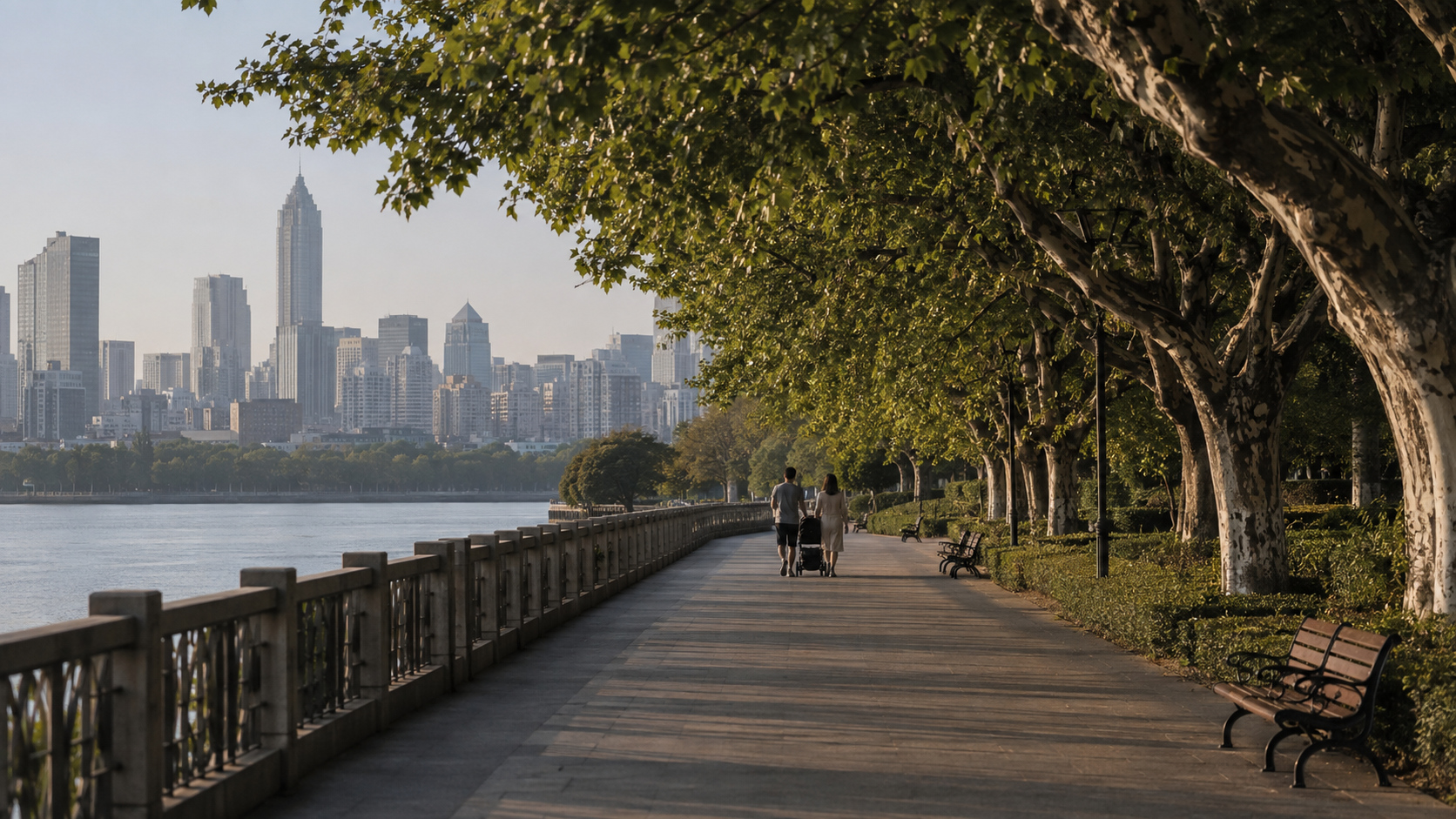 Family with a stroller walking along a calm riverside path in a Chinese city