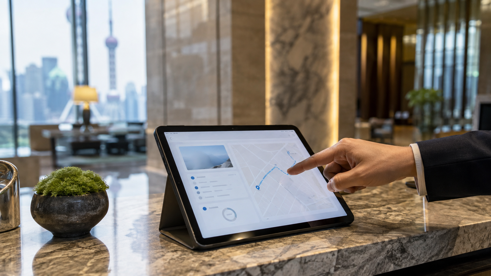Concierge pointing to a route on a tablet in a hotel lobby